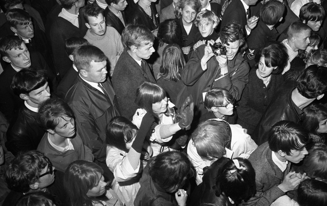 Noi amb una càmera dins la multitud, 1965