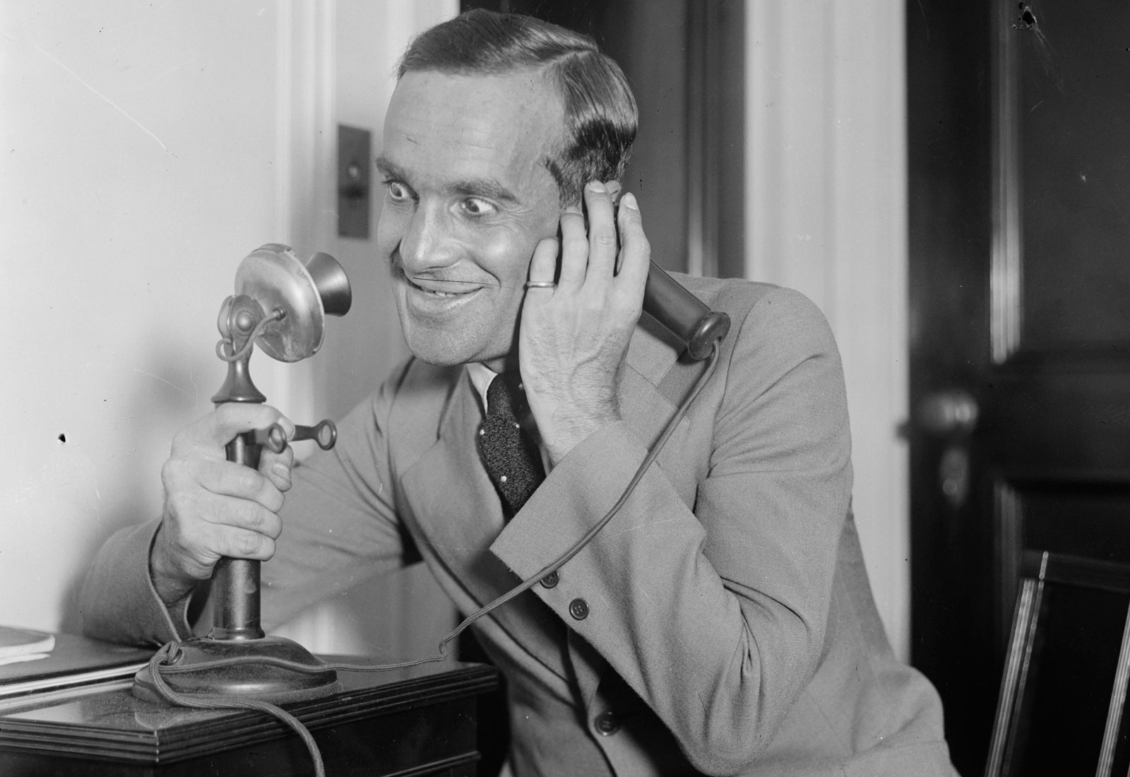 Al Jolson usando un teléfono estilo candelabro, 1910