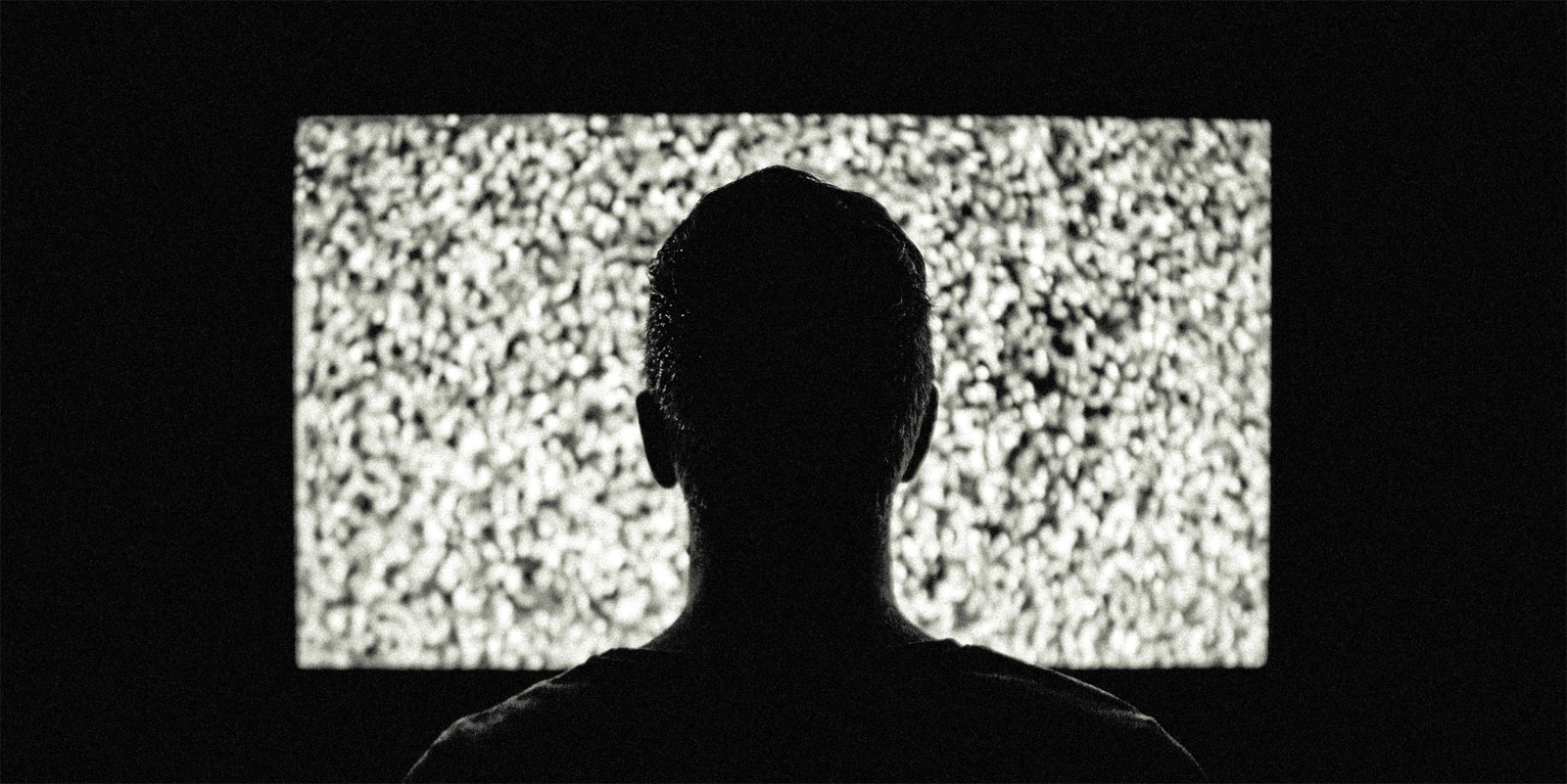 Man in front of a TV with noise